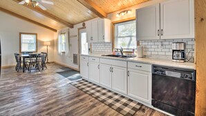 A kitchen with white cabinets, a dishwasher, and a coffee maker. - Waterfront Onamia Retreat w/ Dock & Fire Pit! (Onamia)