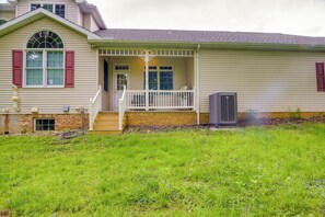 A single-story house with a front porch, a brick foundation, and a large air conditioning unit. - Lancaster Vacation Rental Near Dutch Wonderland! (Lancaster)