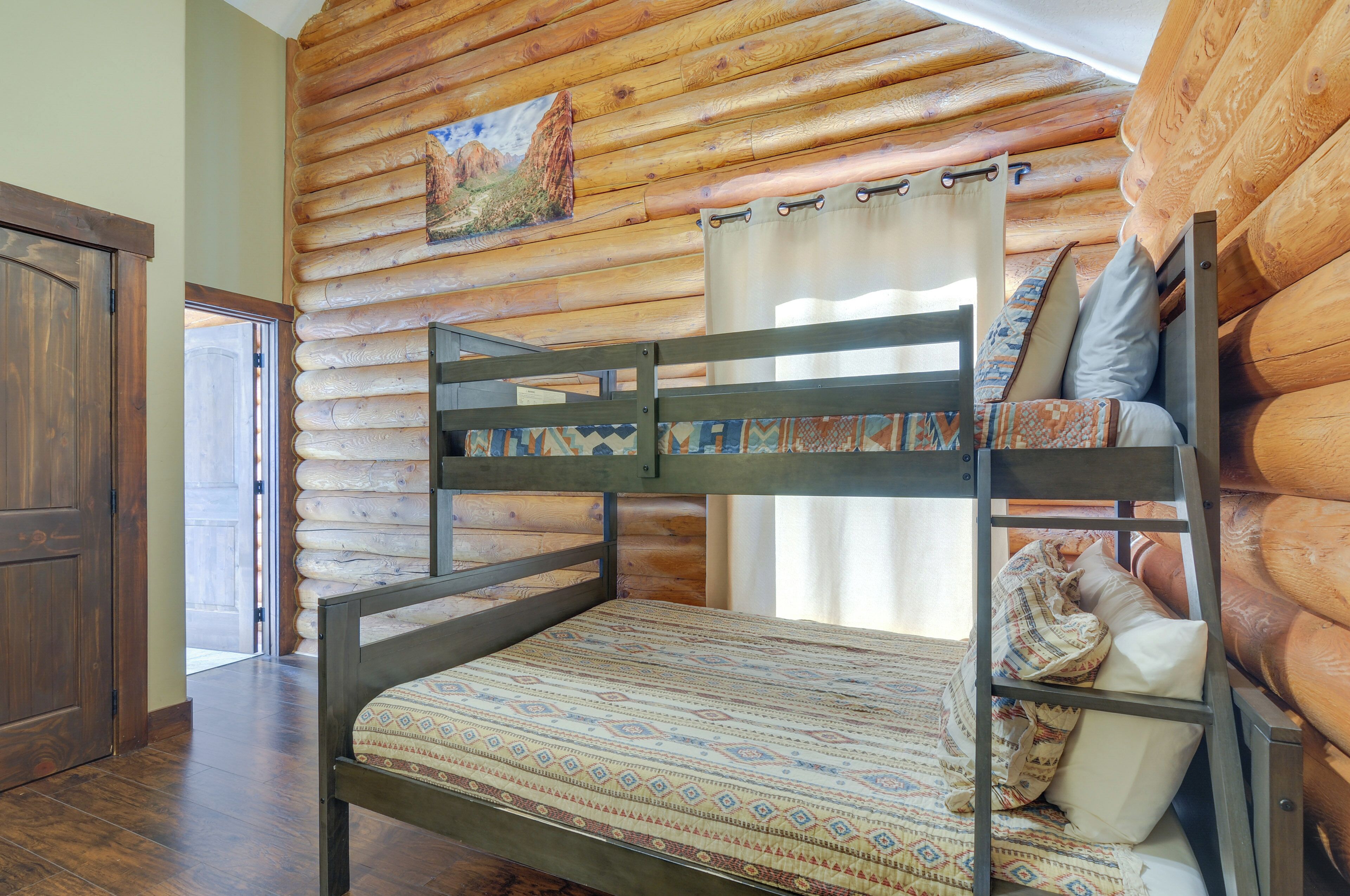 A bunk bed with a patterned mattress, a wooden headboard, and pillows.