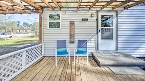 A covered porch with two chairs, a wooden sign, and a welcome mat. - Longview Vacation Rental Home: 4 Mi to Dtwn (Longview)