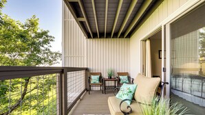 A balcony with a sofa, chairs, and a small table. - Breathtaking Highlands Condo w/ Mountain View (Highlands)