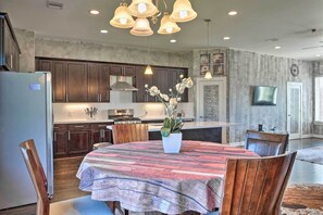 Enjoy meals in the kitchen with a central island and dining area featuring a round table and comfortable seating.