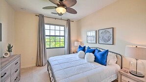A bedroom with a bed, a nightstand, a dresser, a ceiling fan, and a window with curtains. - Alluring Naples Retreat w/ Resort Amenities! (Naples)