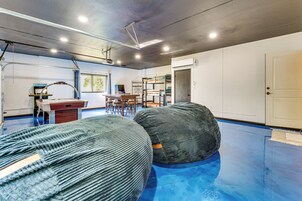 A room with bunk beds, a desk, and a window.