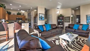 A spacious living room with two brown leather sofas, a white coffee table, and a patterned rug. - Villa w/ Game Room: 10 Mi to Disney! (Davenport)