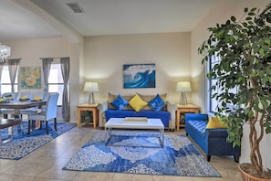 A living room with a sofa, coffee table, and dining area. - Villa w/ Game Room: 10 Mi to Disney! (Davenport)