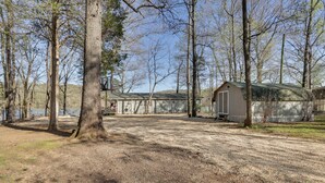 A campground with a large building, a covered area, and a fenced area. - Athens Vintage Fishing Cabin on Elk River! (Athens)