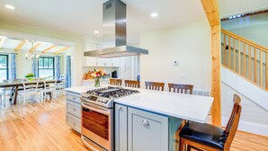 A modern kitchen with a central island, wooden flooring, and a built-in oven. - Stunning Damascus Vacation Rental w/ Fire Pit! (Damascus)