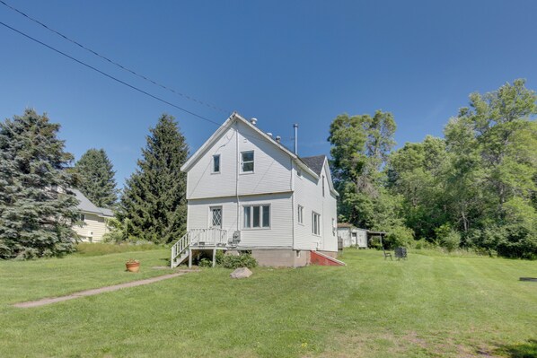 A two-story house with a front porch and a small attached garage. - Sunset Over Kennedy 7 Mi to Big Powderhorn! (Ironwood)