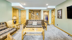 A cozy living room with a sofa, coffee table, and wooden accents. - Quiet Lakefront Conover Cabin Near ATV Trails (Conover)