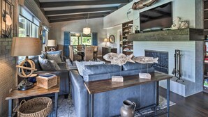 A modern living room with a fireplace, leather sofa, and wooden coffee table. - Chic Family-friendly Home With Outdoor Oasis! (Lampasas)