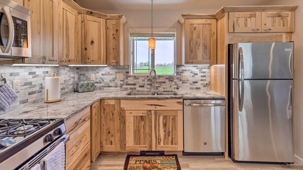 A modern kitchen with wooden cabinets, stainless steel appliances, and a view of the outdoors. - Picturesque Palisade Home: Mt Garfield Views! (Palisade)