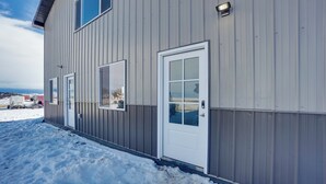 A building with a metal exterior, a white door, and windows. - Saratoga Retreat ~ 3 Mi to Saratoga Lake! (Saratoga)