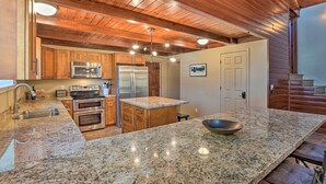 A kitchen with granite countertops, stainless steel appliances, wooden cabinets, and a central island. - Waterfront Clearlake Retreat w/ Dock & Kayaks (Clearlake)