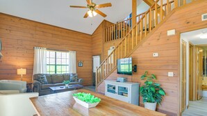 A wooden interior with a dining table, sofa, and staircase. - 3 Mi to Branson Strip! Townhome w/ Deck & Porch (Branson)