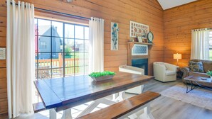 A wooden interior with a dining table, benches, a sofa, and a fireplace. - 3 Mi to Branson Strip! Townhome w/ Deck & Porch (Branson)