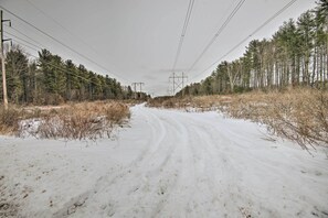 A snow-covered road flanked by trees and power lines. - Charming Studio < 10 Miles to Wells' Beaches! (Wells)