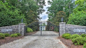 A gated entrance with stone walls and a metal gate, labeled "WHITE OAKS". - Historic 1840's Estate on 20 Acres w/ Guest House (Lafayette)