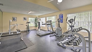 A gym with treadmills, weight machines, and dumbbells. - Laguna Bay Resort Condo ~ 8 Mi to Disney! (Kissimmee)