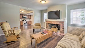 A living room with a fireplace, a television, and a sofa. - Family-friendly Millville Home < 8 Mi to Town (Millville)