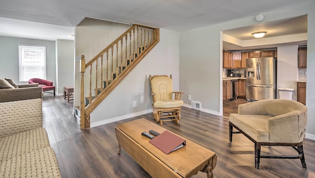 A spacious living room with a wooden staircase, a kitchen with stainless steel appliances, and a comfortable seating area. - Family-friendly Millville Home < 8 Mi to Town (Millville)
