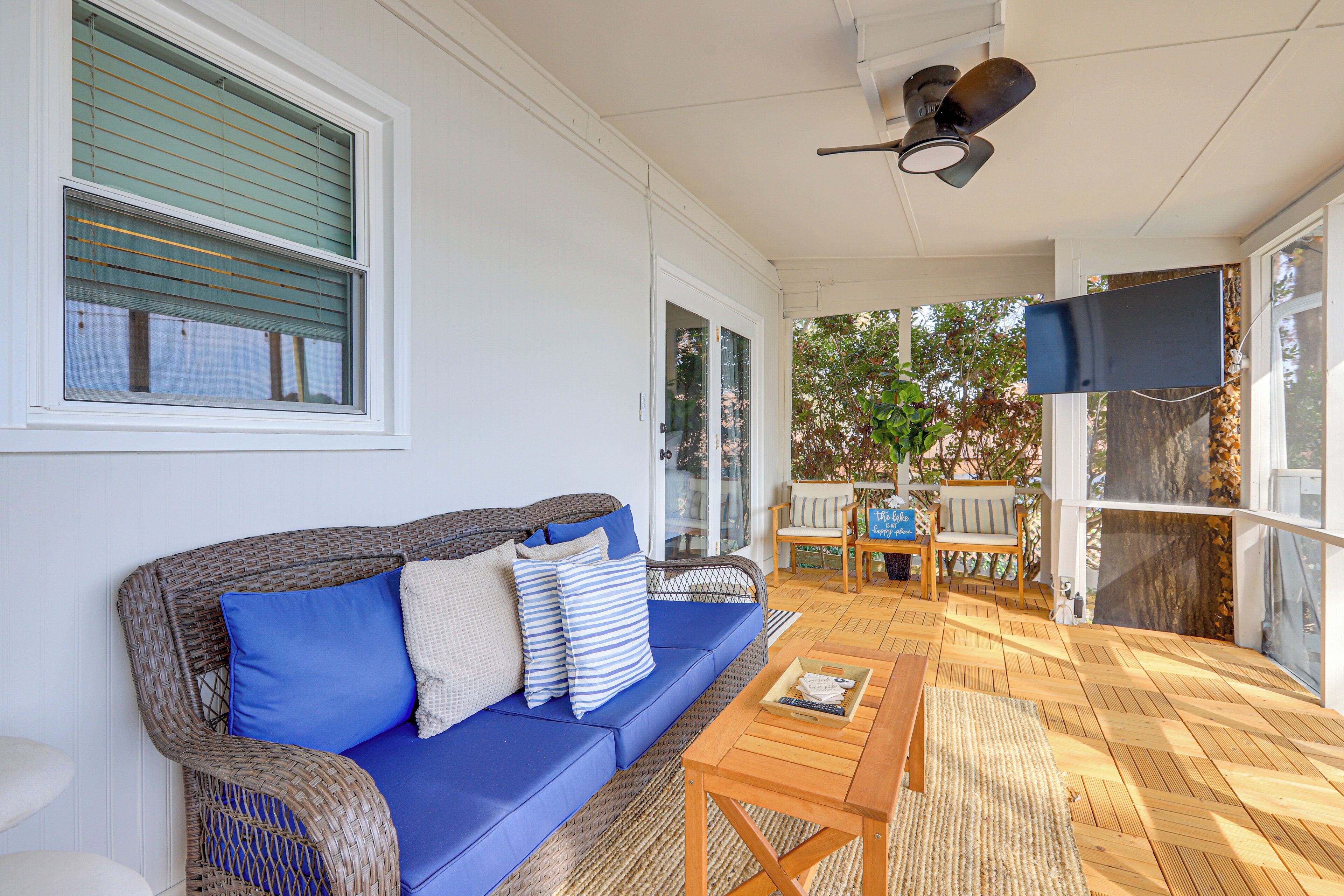 A cozy living area with a blue sofa, a wooden coffee table, and wicker furniture.