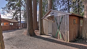 A rustic cabin with a wooden exterior, a door, and a window. - Gorgeous Poulsbo Waterfront Home on Liberty Bay! (Poulsbo)