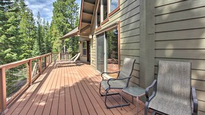A wooden deck with two chairs, a glass door, and a view of a forest. - 5 Mi to Crescent Lake: Dog-friendly Oregon Getaway (Crescent)