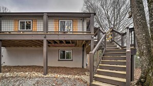 A two-story building with a wooden staircase and a balcony. - 'stonewood Lodge' Couples Retreat in Glenville! (Glenville)