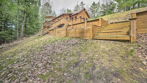 A wooden cabin with a balcony and a staircase leading to the upper level. - Riverfront Lewiston Cabin w/ Stone Fireplace! (Mio)