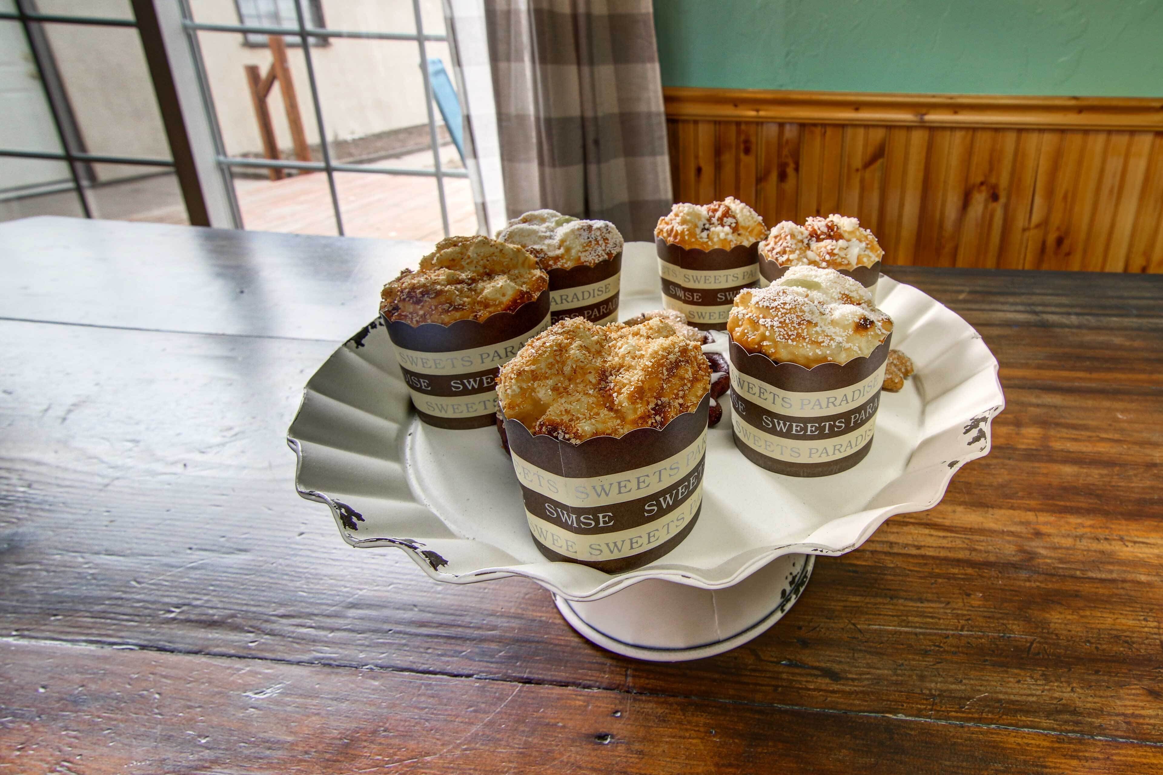A tray of muffins on a table with a wooden background.