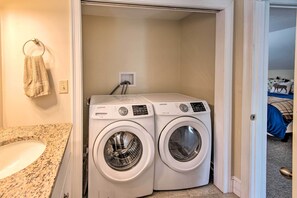 A laundry room with two Samsung washing machines, a towel rack, and a sink. - Beautiful Gilford Home, Near Lake Winni & Gunstock (Gilford)