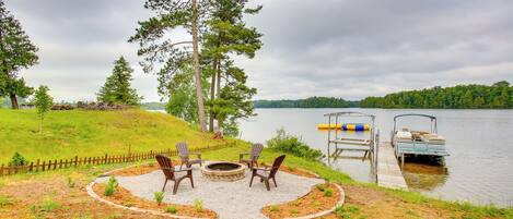 A lakeside patio with outdoor seating and a dock.