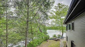 A house with a stone pathway leading to a dock by a lake, surrounded by trees. - Lakefront Granby Escape w/ Private Dock & Kayaks! (Granby)