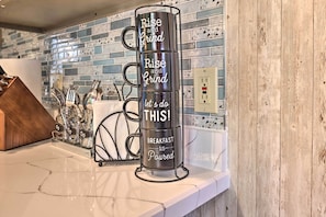 A stack of mugs with motivational phrases on a kitchen counter. - Modern Poconos Gem w/ Fire Pit, Deck & Pool Access (Tobyhanna)