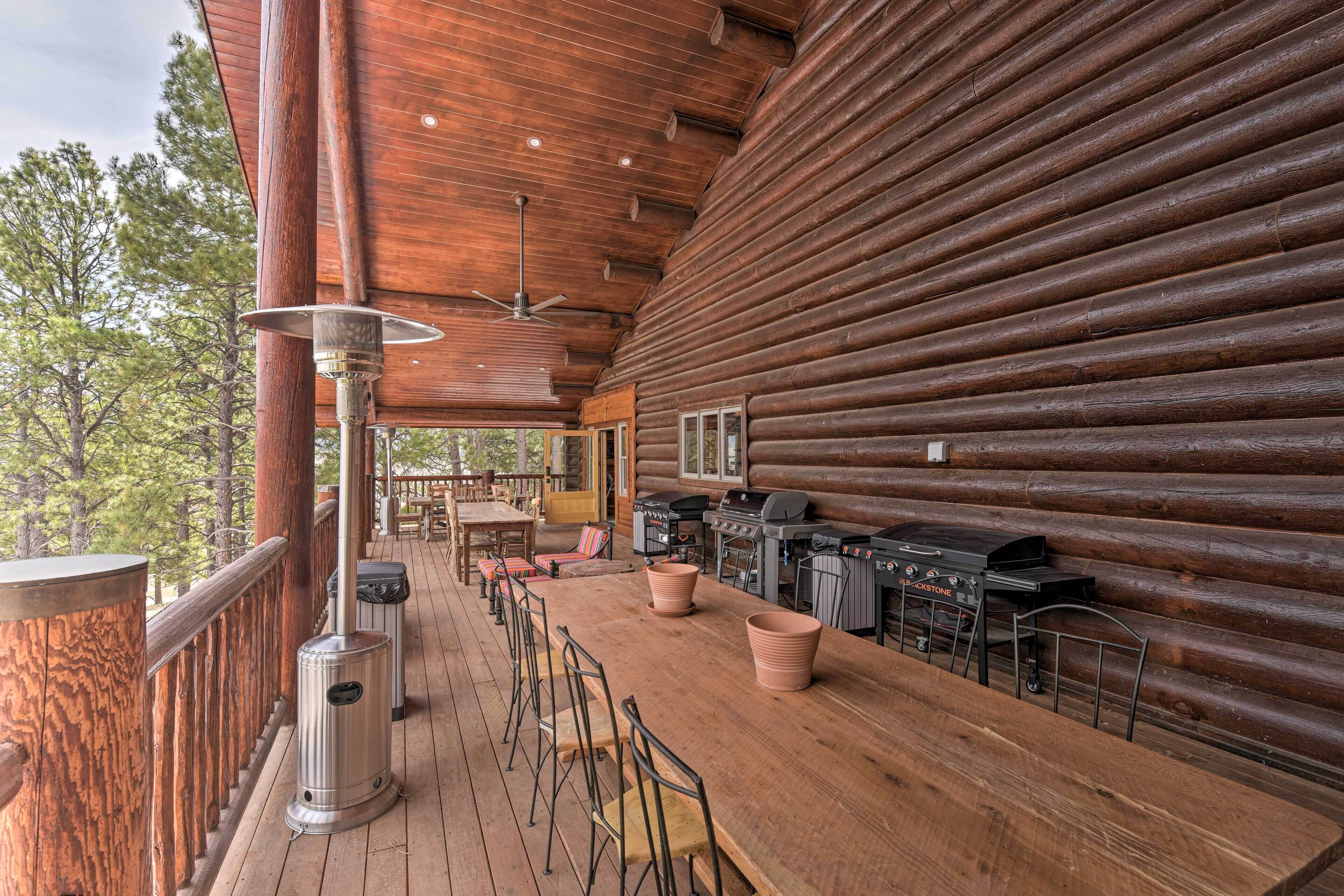 A wooden deck with a bar area, outdoor seating, and a grill station.