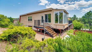 A modern house with a large glass window, a staircase, and a garden. - Breweries, Hiking Trails & Museums: Monument House (Monument)