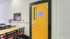 A room with a wooden door, a map on the wall, and a sign indicating the 'Appalachian Suite.' - Family ATV Adventure Hub! Renovated Rental in Gary (Gary)