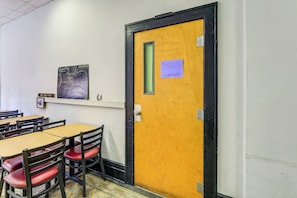 A room with a wooden door, a map on the wall, and a sign indicating the 'Appalachian Suite.'
