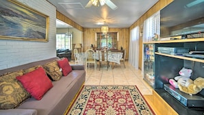 A living room with a sofa, a dining table, chairs, a ceiling fan, and a television. - El Paso Home < 1 Mi to Lone Star Golf Club! (El Paso)