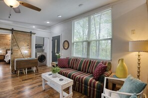Relax in this inviting living space with a sofa, armchair, and coffee table.