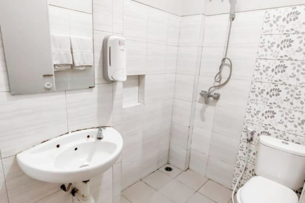 A bathroom with a sink, toilet, and shower.