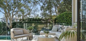 Relax in a serene outdoor space with a clear view of the surrounding greenery and trees.