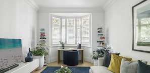 Relax in this inviting space with a comfortable sofa, coffee table, and bookshelf.