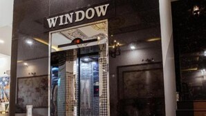 A modern building entrance with a sign that reads "WINDOW". - Window 1 Hotel (Kon Tum)