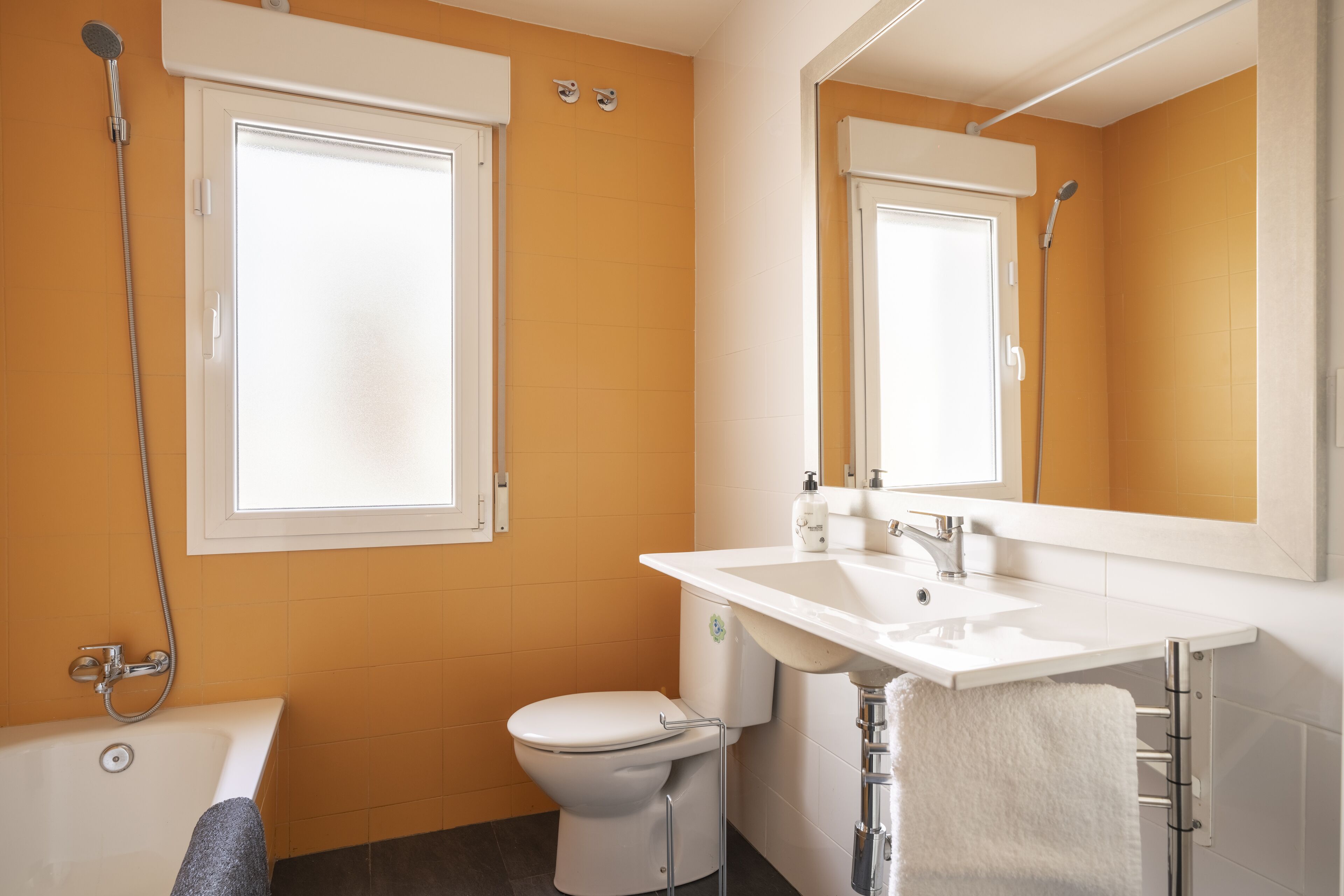 A bathroom with a bathtub, toilet, and sink.