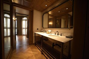 A bathroom with a double sink, a large mirror, and wooden flooring. - Hotel Verdigris (Phuket)