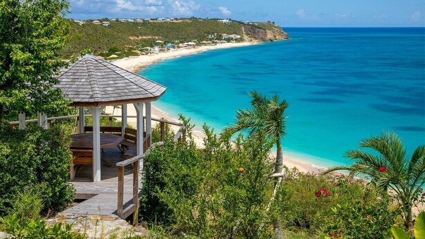 A gazebo with a wooden deck overlooking a beach with clear turquoise waters and a distant shoreline. - Villa Libellule (The Dragonfly) – Elevated Beachfront Elegance in Terres Basses, St. Martin (Philipsburg)