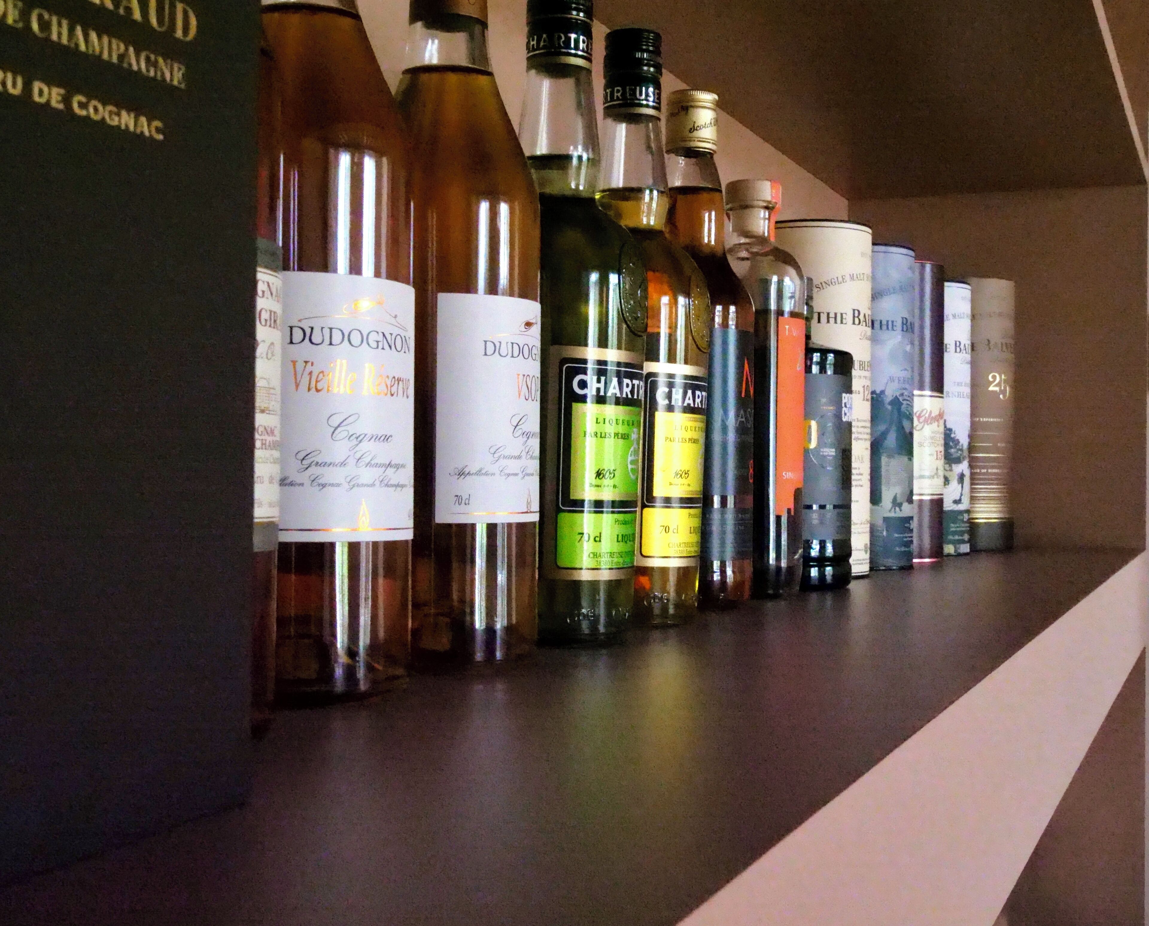 A row of liquor bottles on a shelf.