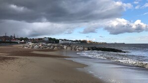 A beach with a rocky breakwater, a pier extending into the sea, and buildings in the background. - Attractive apartment which has, possibly,  the best views in Felixstowe (Felixstowe)
